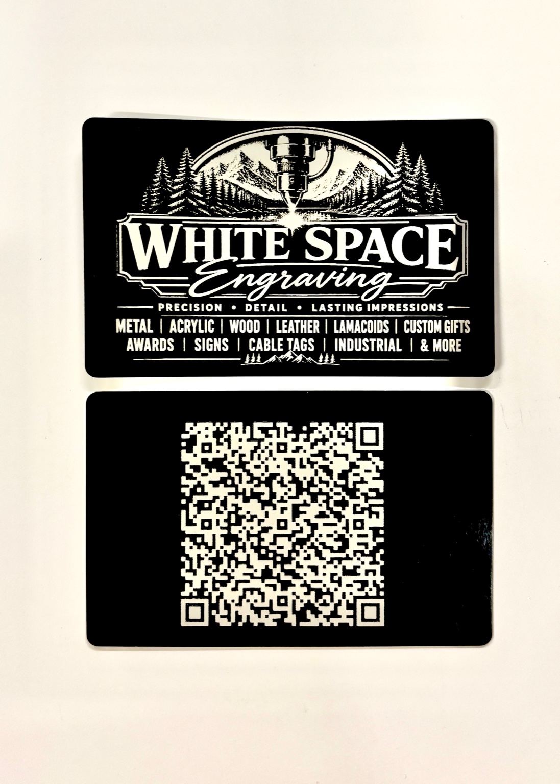 Custom engraved aluminum business cards with detailed logo, contact information and QR code