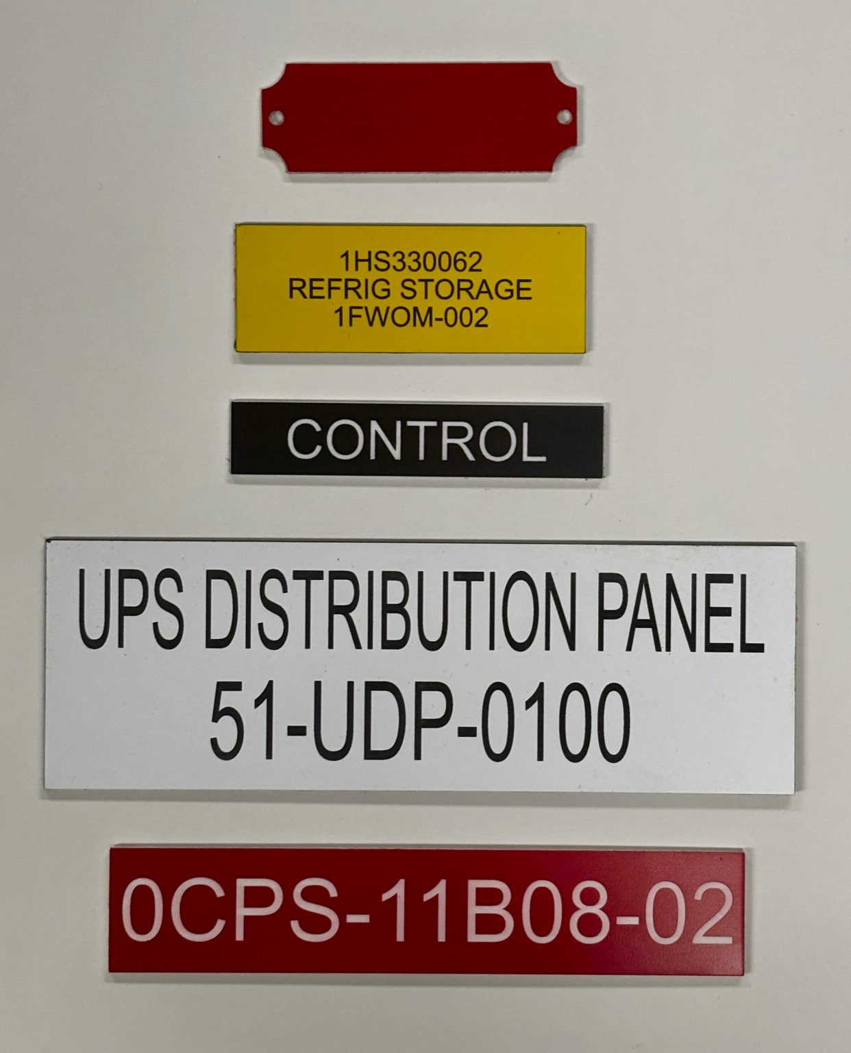 Assorted engraved industrial lamacoid labels and equipment identification tags